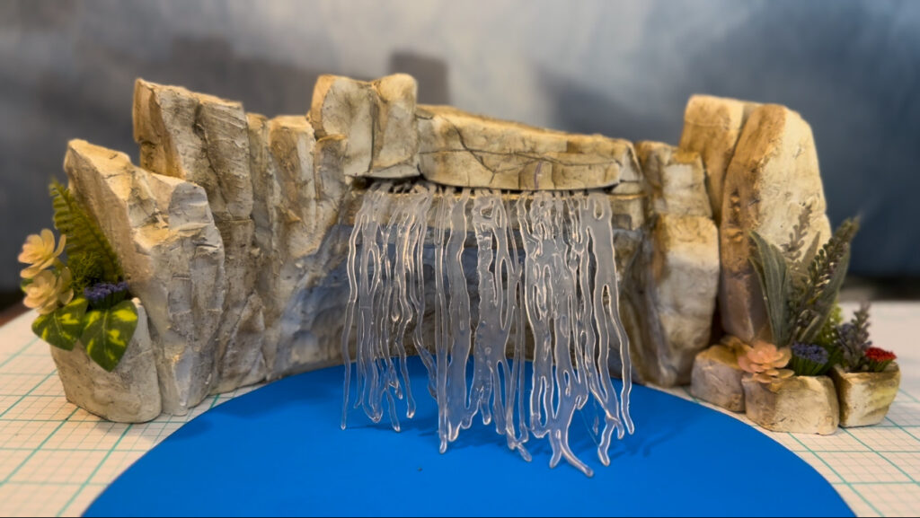 faux rock swimming pool waterfall design 
