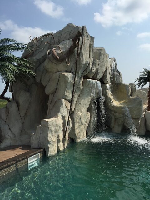 Custom waterfall upgrade added to an existing swimming pool in Florida by Boulder Legacies